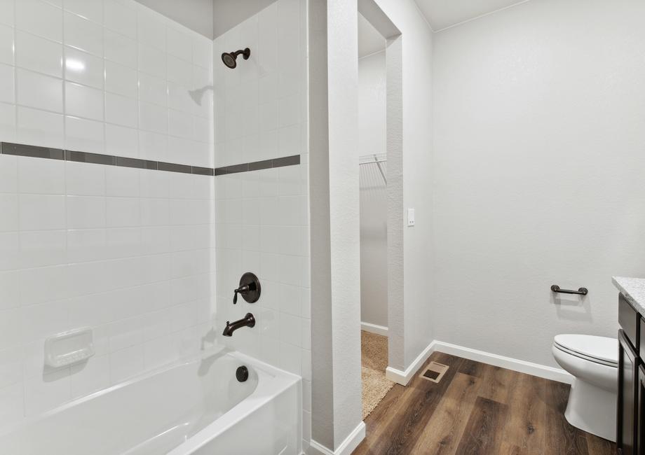 The master bathroom also features a dual shower and bath tub and a walk-in closet.