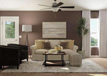 Rendering of living
  room with ceiling fan, window and door to back yard decorated with a
  cream-colored couch and two black accent chairs