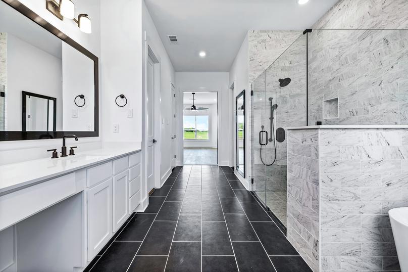 Breathtaking master bath with tile flooring and a large vanity.
