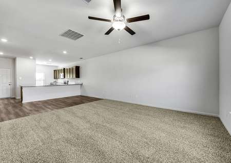 Large, carpeted family room with more than enough space for hosting. 