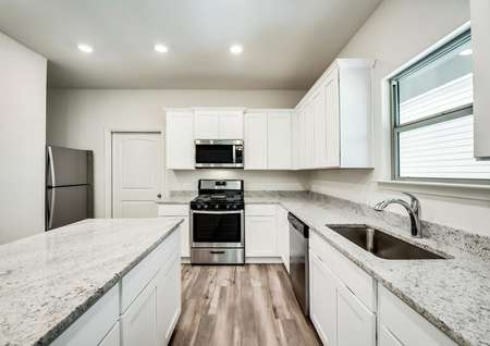 Stunning kitchen featuring a gas stove, granite countertops and stainless steel appliances.