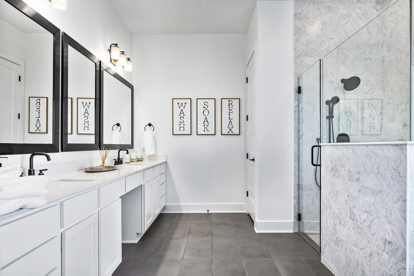 The master bath features an oversized walk-in shower and soaking tub.