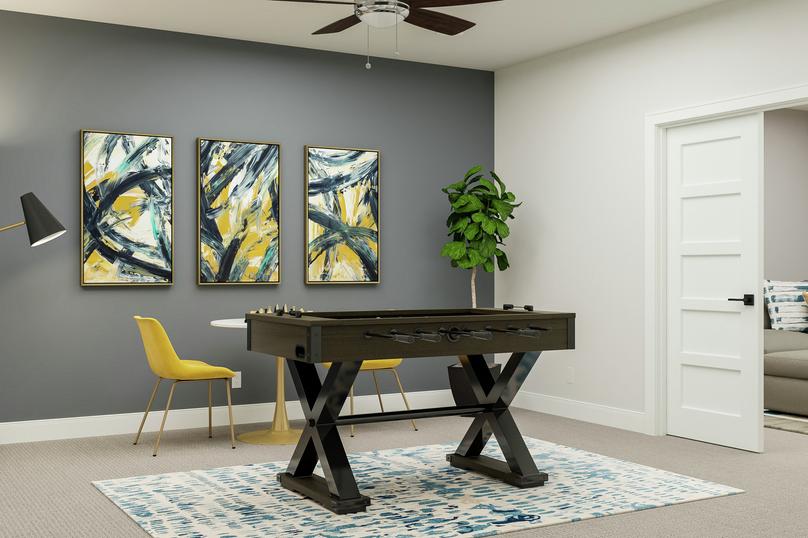 Rendering showing an accent wall in the
  second story loft with abstract paintings behind a foosball table, floor lamp
  and three-piece dining set.