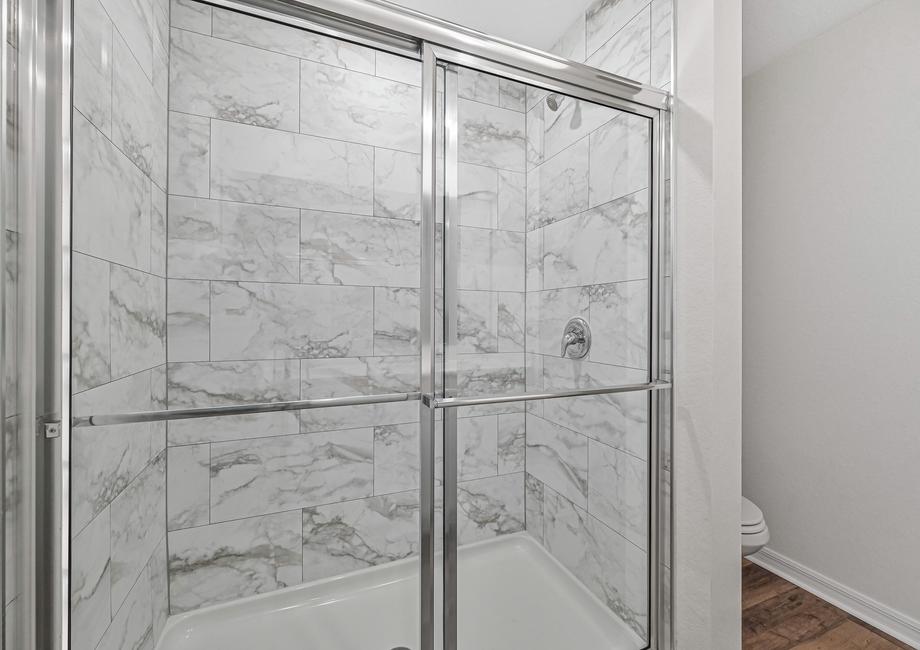 The master bathroom of the Capri has a beautifully tiled shower
