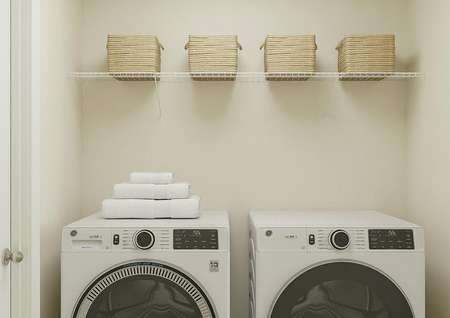 Rendering of the laundry room with a washer, dryer and shelf with baskets.