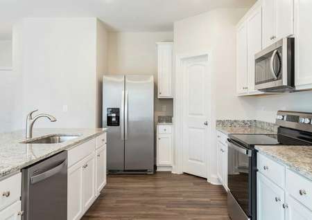 Hartford kitchen with light color granite, wood flooring, and modern appliances