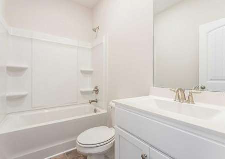 Allatoona guest bath with bath/shower, white vanity housing, and large mirror