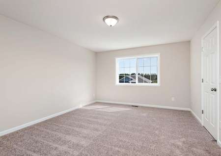 Photo of a bedroom with carpet and window overlooking the front yard.