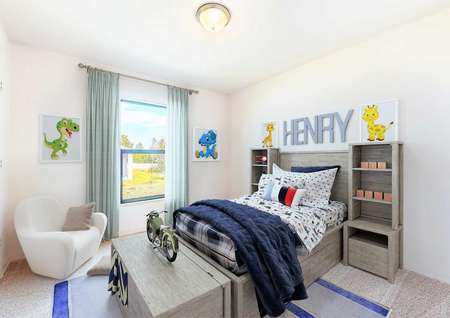 A fully furnished model bedroom with children's paintings on the white walls, a chair and a bed set.