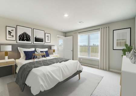 Staged master bedroom with a gray bed with white linens.