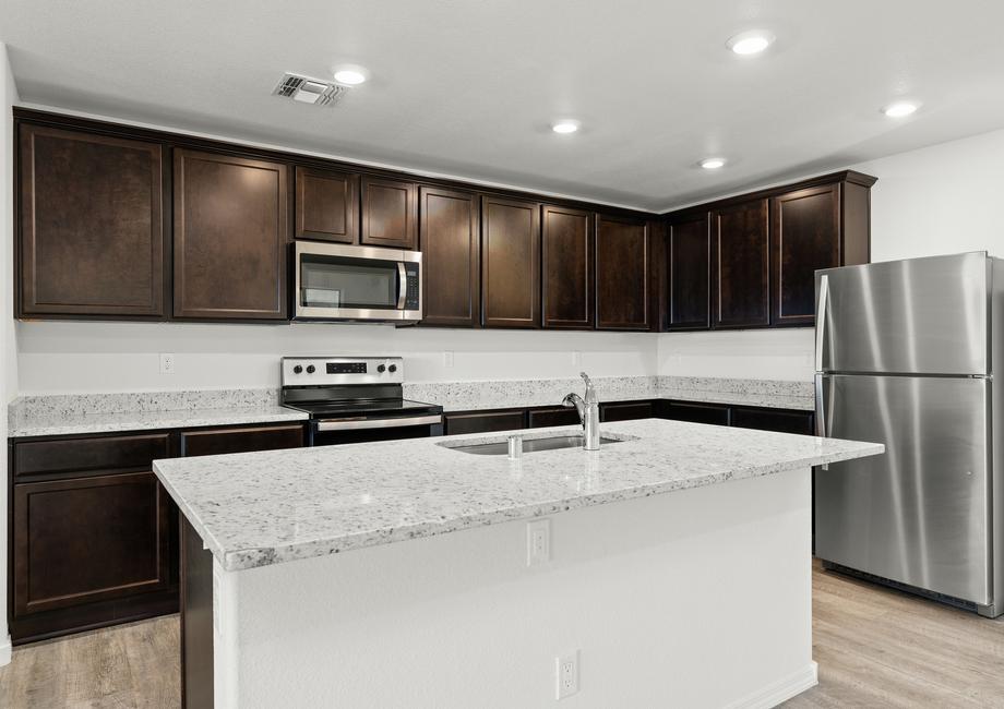 Designer kitchen with a large granite island and stainless appliances.
