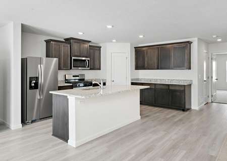 The kitchen is chef-ready with stainless steel appliances