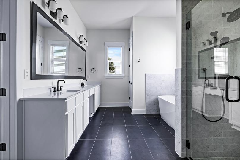 Luxurious master bathroom with a dual sink vanity, soaking tub, and walk-in shower.