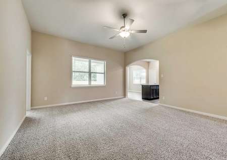 Erie open plan with carpet, ceiling fan, and white-framed windows