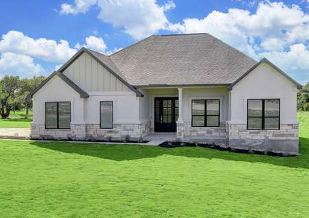 The Fairview plan is a spacious single story home with white stucco and tan stone accents.