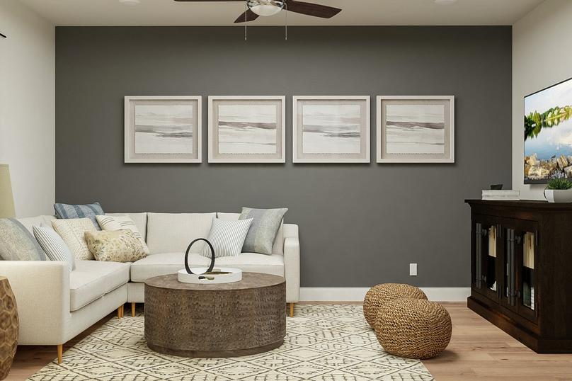 Rendering showing the sitting room with
  large sectional and coffee table on top of a geometric rug. A wood media
  cabinet offsets the grey accent wall and abstract paintings.