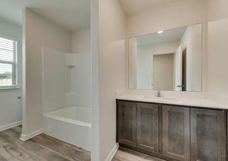The secondary bath has a great vanity and shower/tub combo.