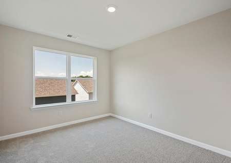 The master suite has brown carpet and tan walls with white trim.