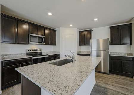 Stunning kitchen with stainless appliances and granite countertops.
