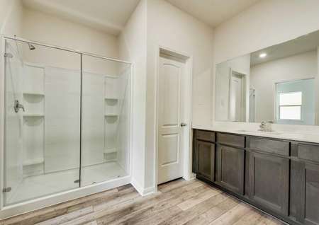 The master bath has a large glass enclosed shower and spacious vanity.