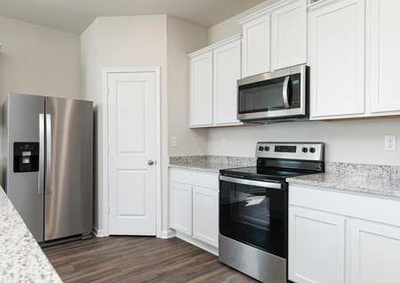 The kitchen is chef-ready with stainless steel appliances