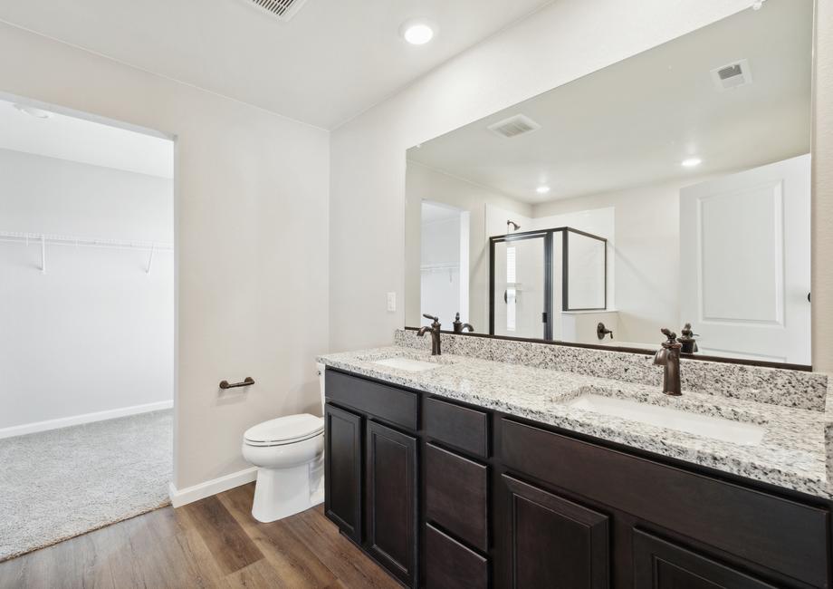 Master bathroom with a dual sink vanity and a walk-in shower and bathtub.