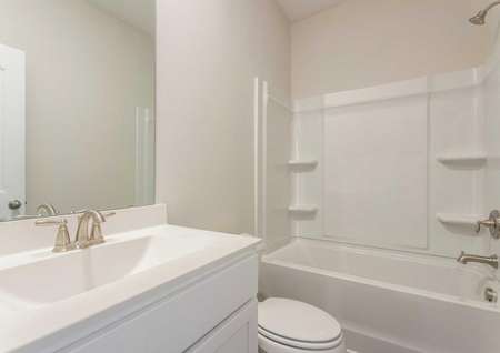 Burton guest bath with white fixtures, bathtub/shower combo, and modern sink