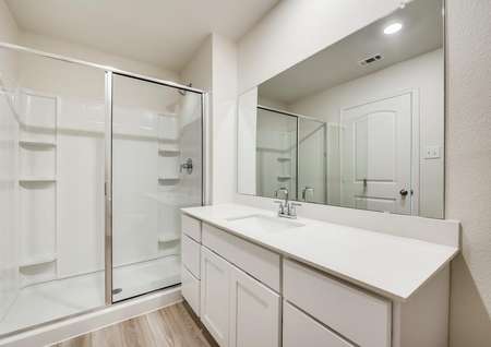A full bathroom with spacious, white countertops. 