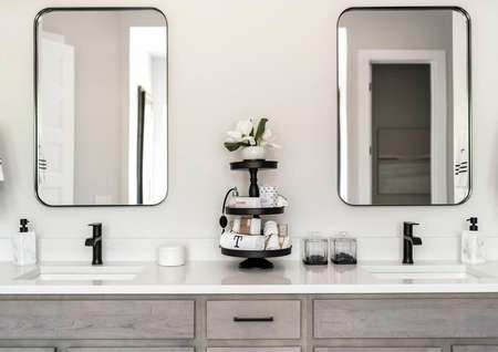Dual sink vanity with two large mirrors and black accents