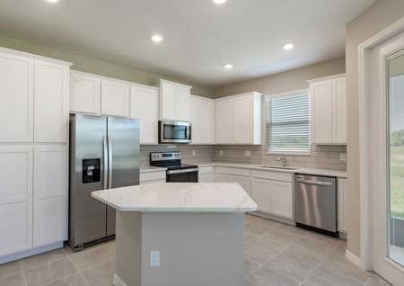 The Tuscany kitchen floor plan has stainless steel appliances, an island and quartz countertops.