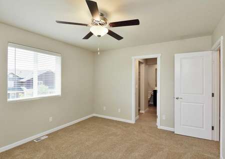 The Northwest Chelan master bedroom is carpeted with ceiling fan and attached in suite master bathroom.
