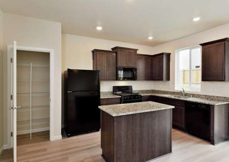 Cypress kitchen with custom cabinets, granite finish countertops, and wood style floors