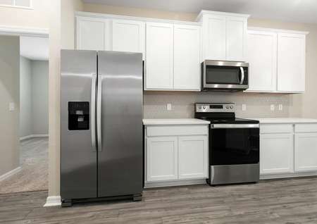 Close up of stainless steel appliances and white cabinetry in the heart of the home.