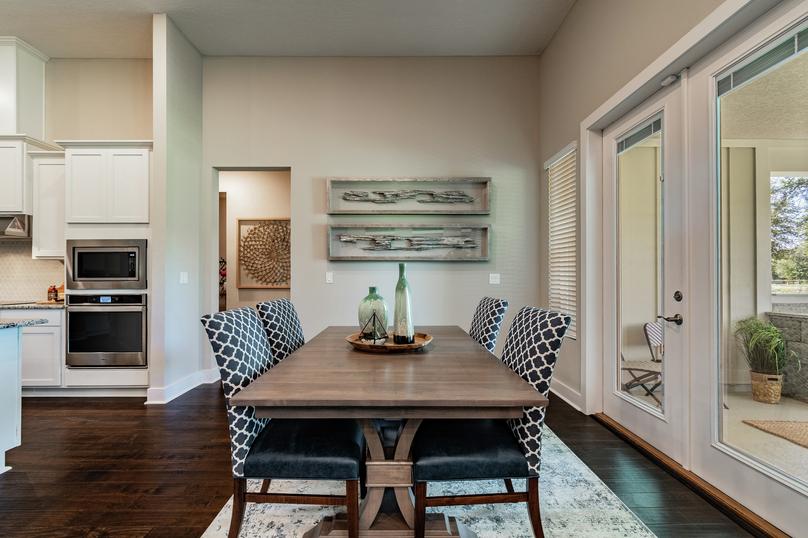 Dining area with table, chairs and art.