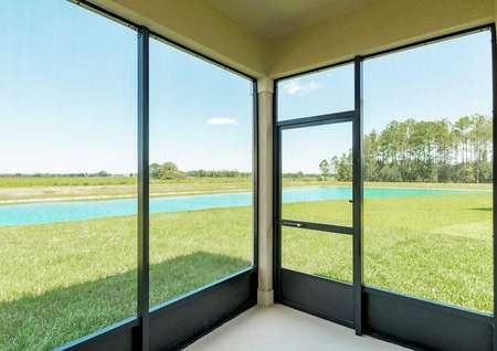 An enclosed and covered patio in the Tuscany floor plan with an open view of a golf course.