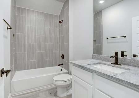Guest bathroom with dual shower and tub, white cabinets, and granite countertops.