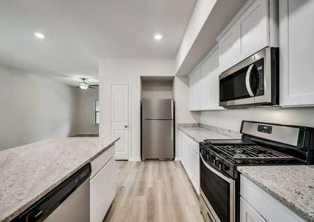 A chef-ready kitchen that includes a gas stove and beautiful granite countertops.