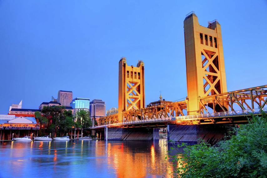 Sacramento, California Tower Bridge over the Sacramento River taken at night with lights reflecting off the water
