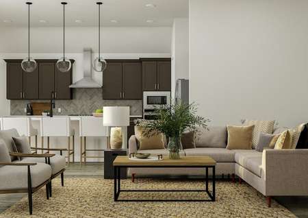 Rendering of the open floor plan in the
  Liberty. The room is furnished with a large sectional, two accent chairs, a
  coffee table, with a view of the kitchen in the background.
