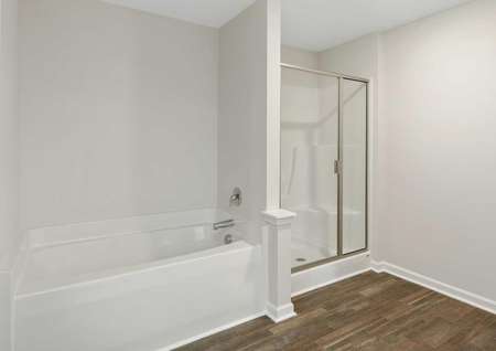 Burton master bathroom with separate shower and bathtub, recessed lights, and white trimmed walls