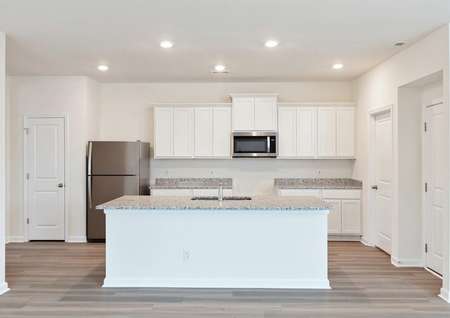 Kitchen with island and white cabinets.