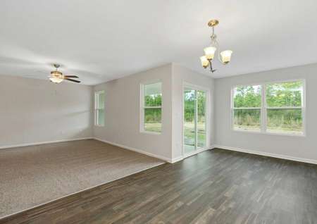 Burton great room with carpet in the family room, hardwood-style tile in the dining nook, and ceiling lights in both