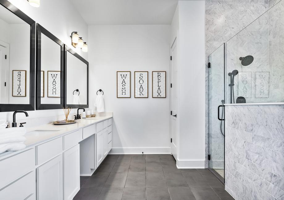 The master bath features an oversized walk-in shower and soaking tub.