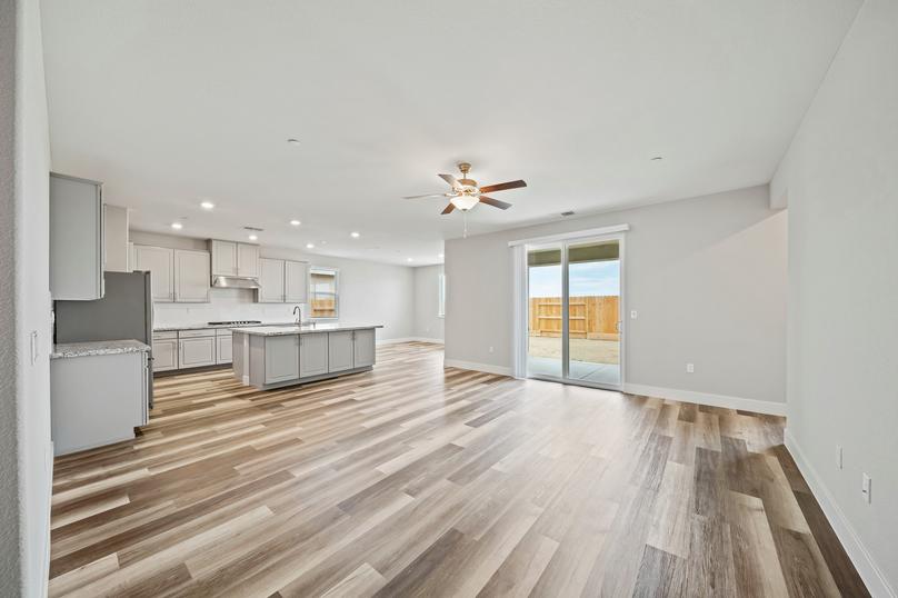 Open-concept layout with a spacious living room, designer kitchen, and breakfast area.