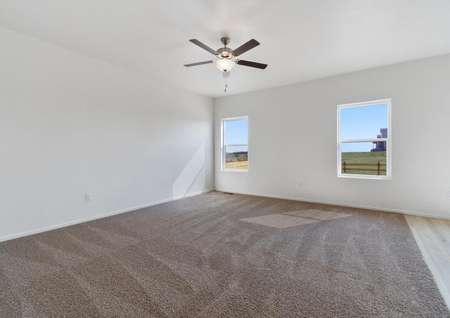 Spacious living room with ceiling fan and access to the dining area.