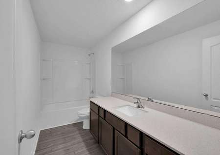 Long countertop space in one of the secondary bathrooms of the home.