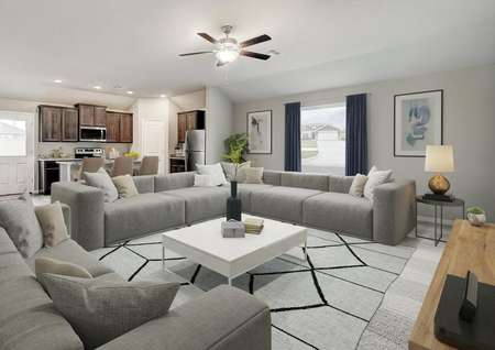 Staged living room with two large gray couches.
