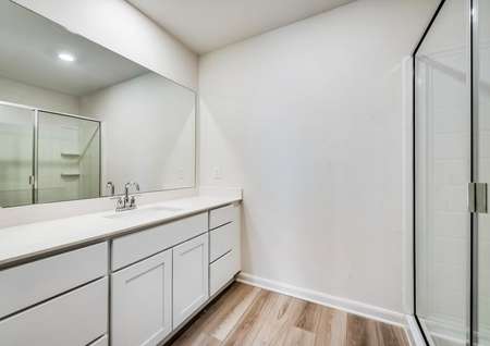 A full bathroom with white, spacious countertops.