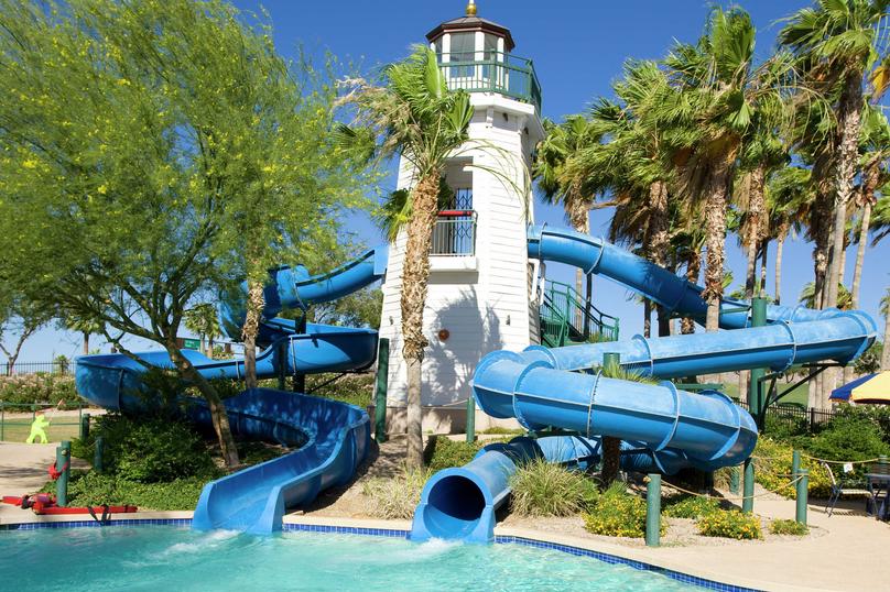 Water park with slides leading into the pool in the Estrella community