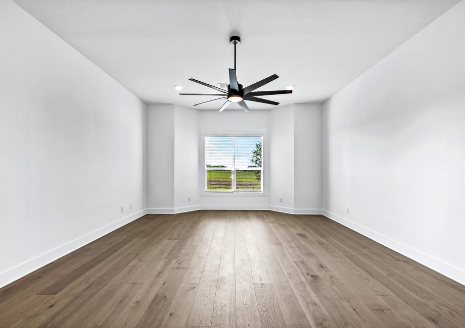 Fall in love with the incredible master bedroom with wood flooring and a ceiling fan.